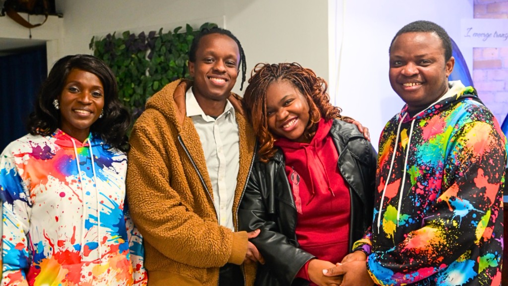 Four TIA community members standing together and smiling