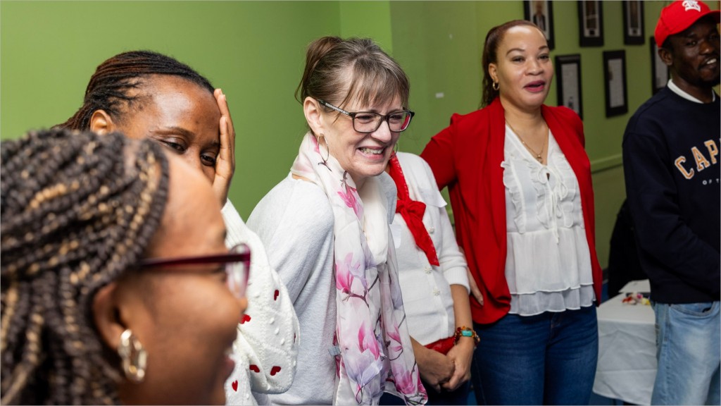 Community members laughing together at a TIA gathering.