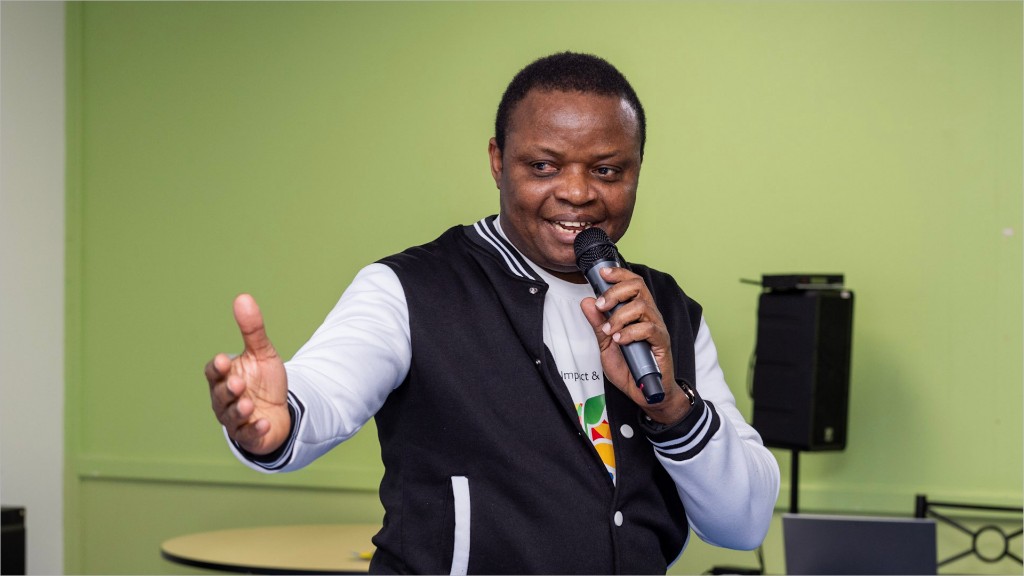 A TIA speaker addressing a room with a microphone.