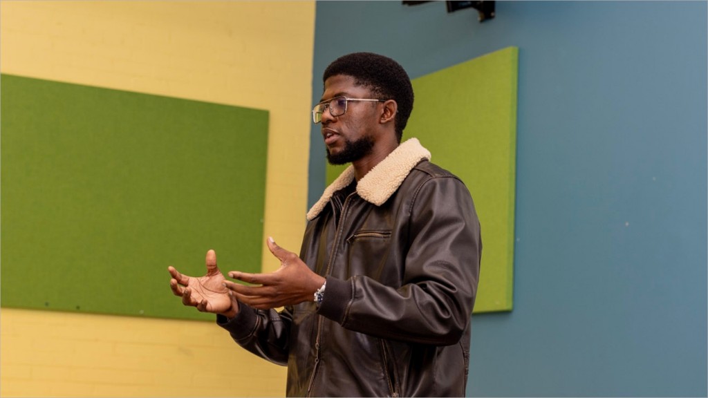 A facilitator speaking with open hands during a pathways workshop.