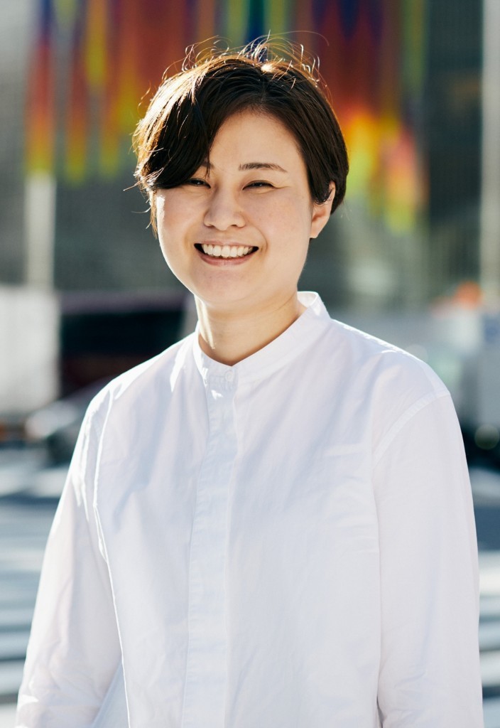 A smiling newcomer in a white shirt