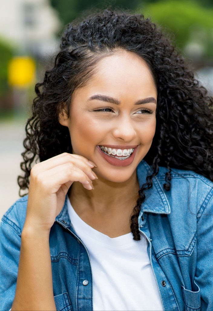 A young woman smiling outdoors